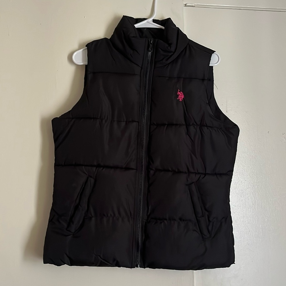 Black sleeveless padded vest.